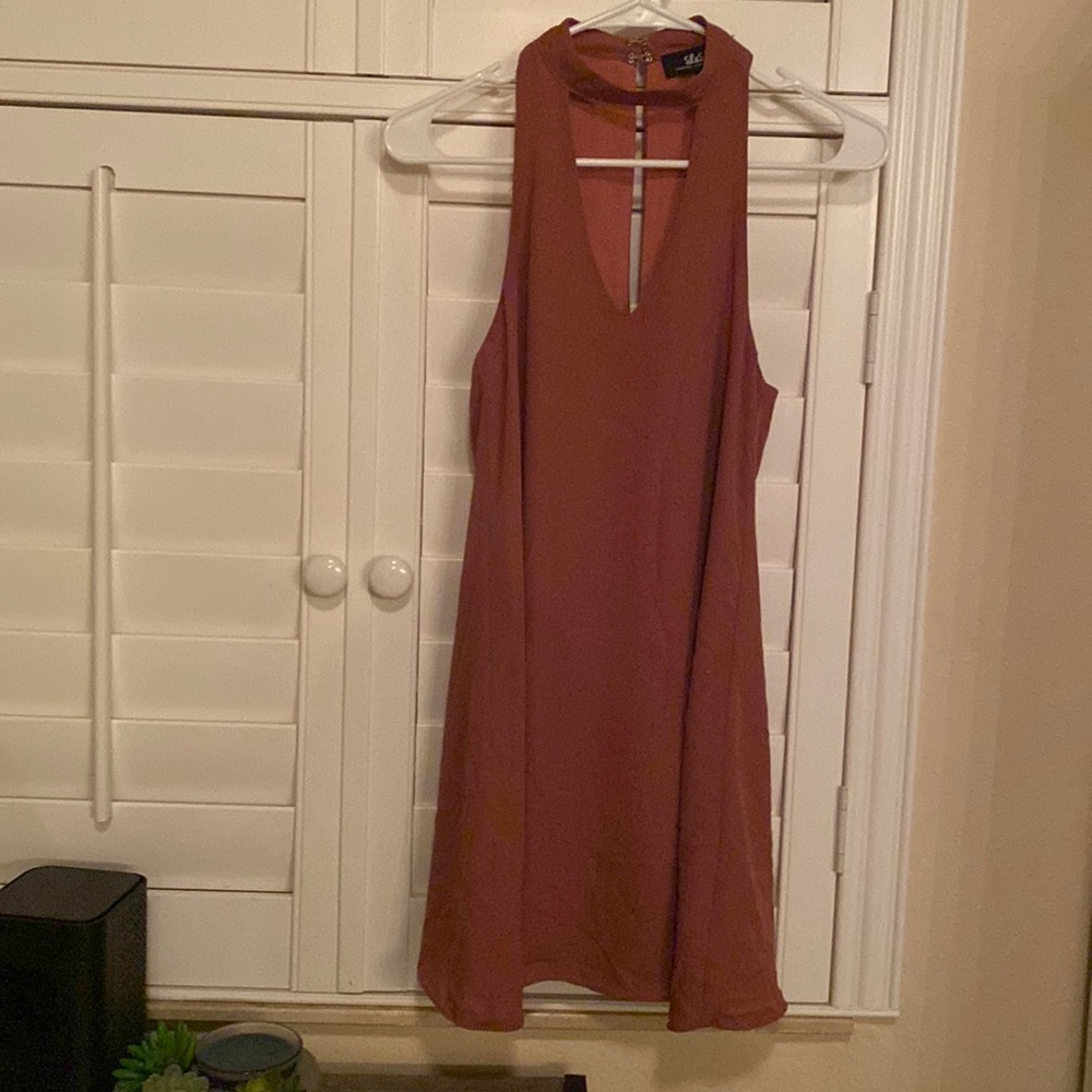Loose fitting above the knee dress, around the neck
